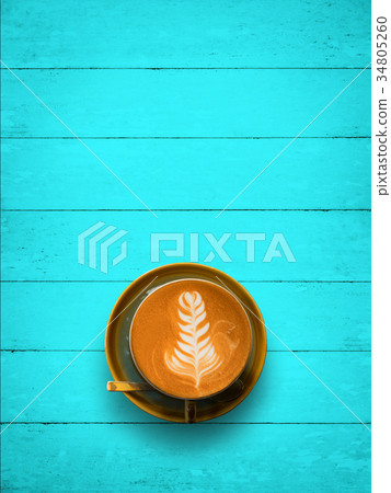Top view of hot coffee cup on blue wood table Top view of hot coffee cup on blue wood table 34805260