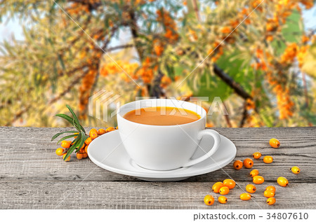 Tea of seabuckthorn berries on wooden table Tea of seabuckthorn berries on wooden table 34807610