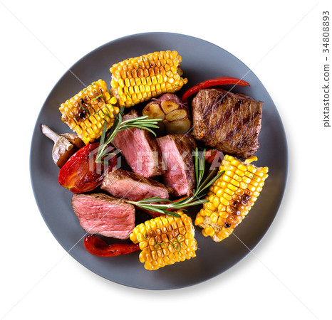 Round blue plate with pieces of chopped steak 34808893