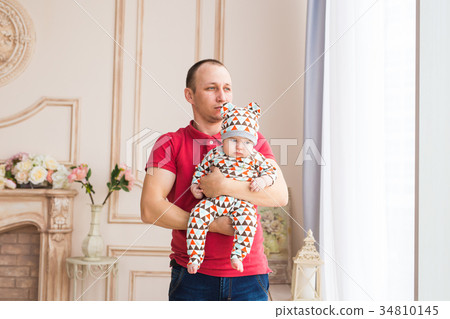 Adorable Caucasian baby and his father. Portrait Adorable Caucasian baby and his father. Portrait 34810145