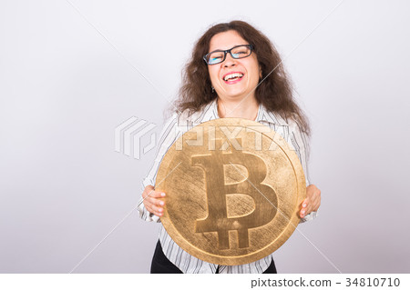Business woman holding a Golden Bitcoin. Virtual Business woman holding a Golden Bitcoin. Virtual 34810710