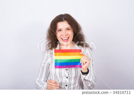 Young lesbian woman holding flags of the LGBT Young lesbian woman holding flags of the LGBT 34810711