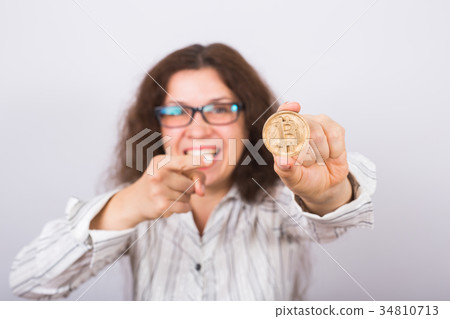 Happy business woman showing Golden Bitcoin coin 34810713