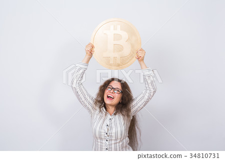 Business woman holding a Golden Bitcoin. Virtual 34810731