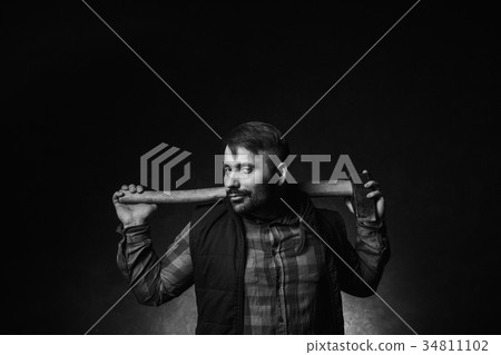 Strong smirking seductive worker holding axe 34811102