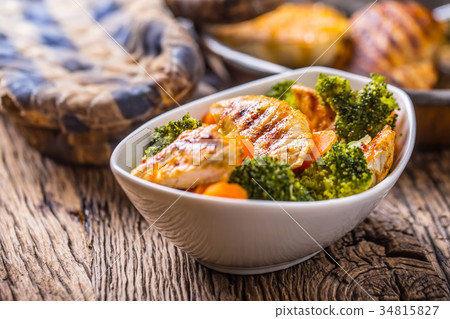 Pieces of grilled chicken with carrot and broccoli Pieces of grilled chicken with carrot and broccoli 34815827