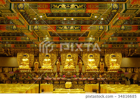 Golden Buddha statues in interior of the temple 34816685