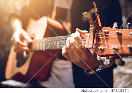 Asian hipster man left hand catch chord Asian hipster man left hand catch chord 34818374