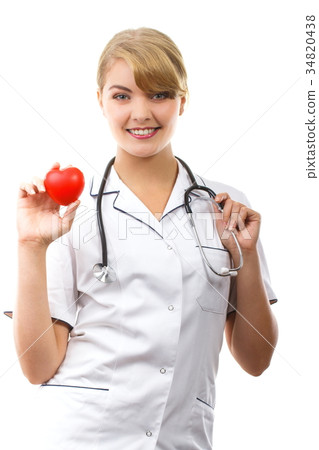 Woman doctor with stethoscope holding red heart Woman doctor with stethoscope holding red heart 34820438