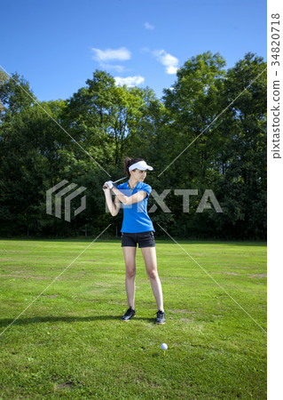 Pretty girl playing golf on grass Pretty girl playing golf on grass 34820718