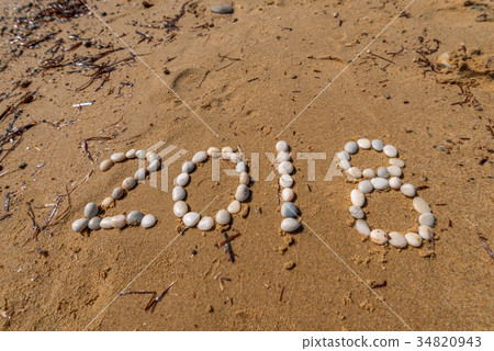 2018 New Year text on sand 34820943