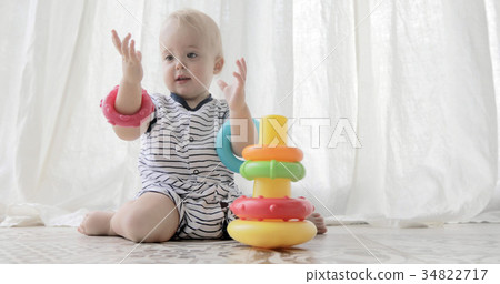 Adorable baby playing with toys 34822717