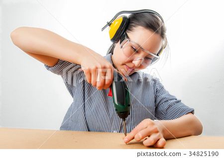 Young woman with a drill 34825190
