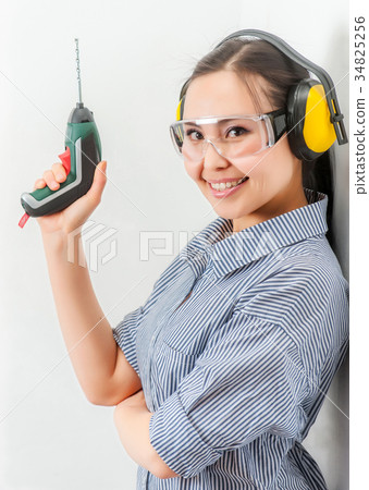 Young woman with a drill 34825256