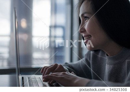 Female using laptop 34825308