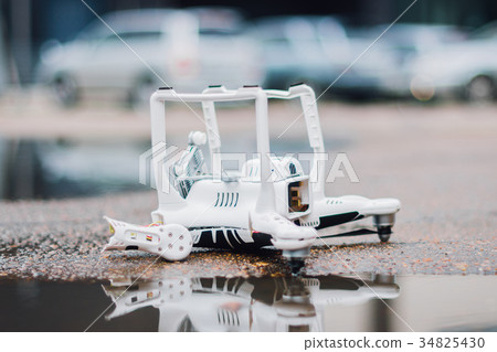 Crashed drone on the ground 34825430