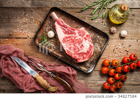 Raw tomahawk beef steak Raw tomahawk beef steak 34827584