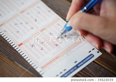 Photo on top of person marking in lottery ticket Photo on top of person marking in lottery ticket 34828039