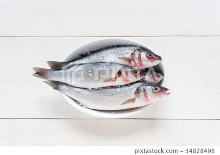 Fresh raw fish with salt on the white dish Fresh raw fish with salt on the white dish 34828498