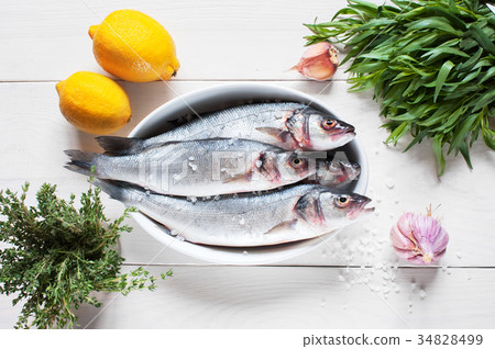 Raw fresh fish on the wooden table Raw fresh fish on the wooden table 34828499