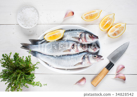 Raw fresh fish on the wooden table Raw fresh fish on the wooden table 34828542