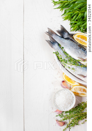 White wooden background with fresh raw fish White wooden background with fresh raw fish 34828544