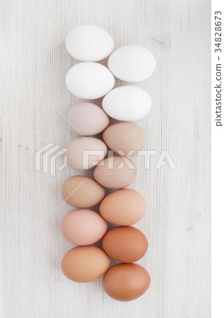 Various eggs on the white wooden table 34828673