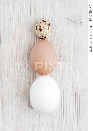 Various eggs on the white wooden table 34828674
