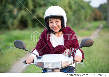 Active senior to ride a scooter 34829207