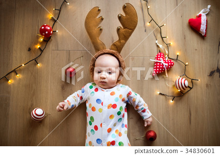 Little baby boy on the floor at Christmas time. Little baby boy on the floor at Christmas time. 34830601
