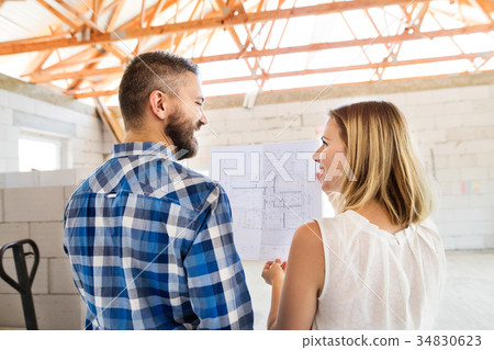 Young couple at the construction site. Young couple at the construction site. 34830623