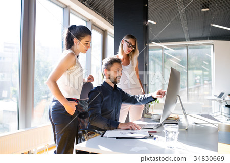 Three business people in the office working Three business people in the office working 34830669