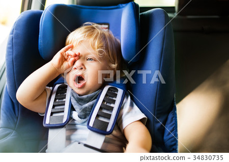Little boy sitting in the car seat in the car. Little boy sitting in the car seat in the car. 34830735