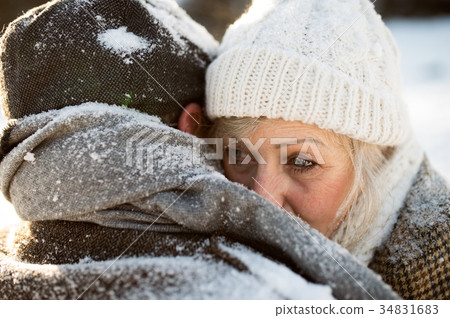 Beautiful senior couple in sunny winter nature. 34831683