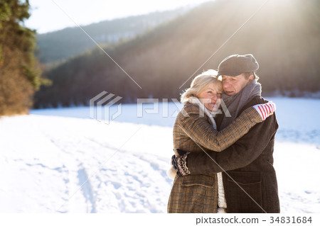 Beautiful senior couple on a walk on sunny winter 34831684