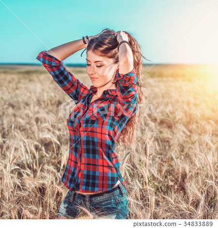 Girl in a field shirt shorts, wheat outdoor 34833889