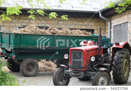CLose up on tractor with the barn 34835706