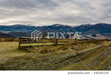 fence on grassy meadow in autumn 34836329