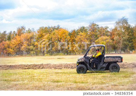 Hunting quad bike with driver in mask Hunting quad bike with driver in mask 34836354
