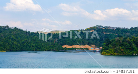 Mountain, lake and blue sky with white clouds Mountain, lake and blue sky with white clouds 34837191