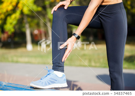 Female runner touching cramped calf at jogging 34837465