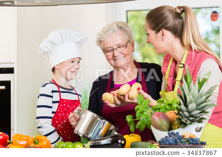 Family cooking in multigenerational household with 34837867