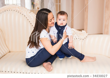 Adorable Caucasian baby boy with his mother 34838027