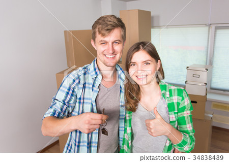 Happy funny couple showing keys of new home 34838489
