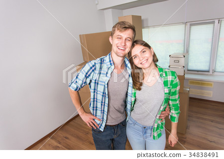 Happy funny couple moving in a new house. Happy funny couple moving in a new house. 34838491