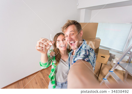 Happy funny couple showing keys of new home 34838492