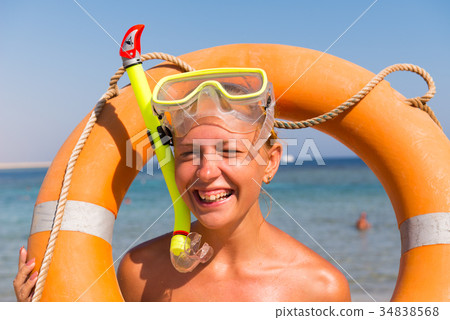 Cheerful woman wearing snorkeling mask 34838568