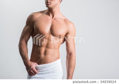 Attractive guy is posing against white wall 34839024