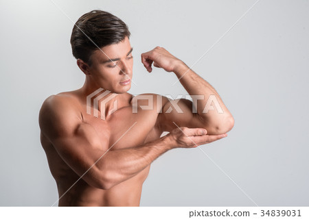 Pleasant charming guy is standing naked Pleasant charming guy is standing naked 34839031
