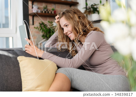 Outgoing female listening song in room Outgoing female listening song in room 34839817